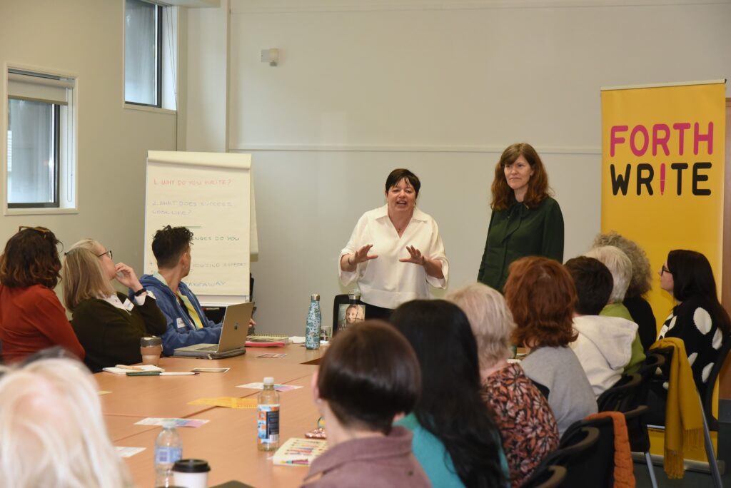 Workshop members around a table with flipchart at front